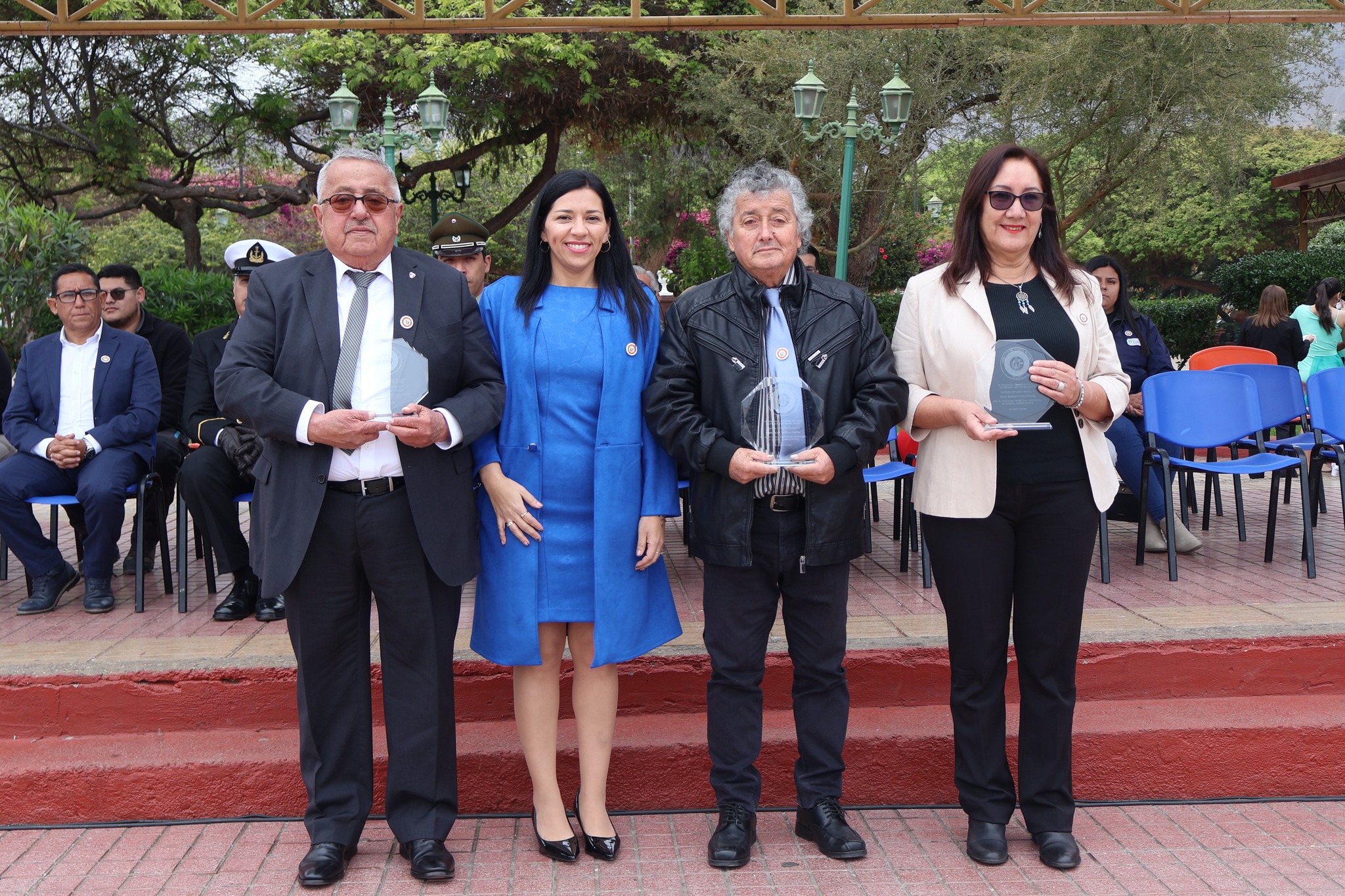 Directora y docentes posan con reconocimientos en la plaza principal durante ceremonia del Liceo Politécnico de Taltal.