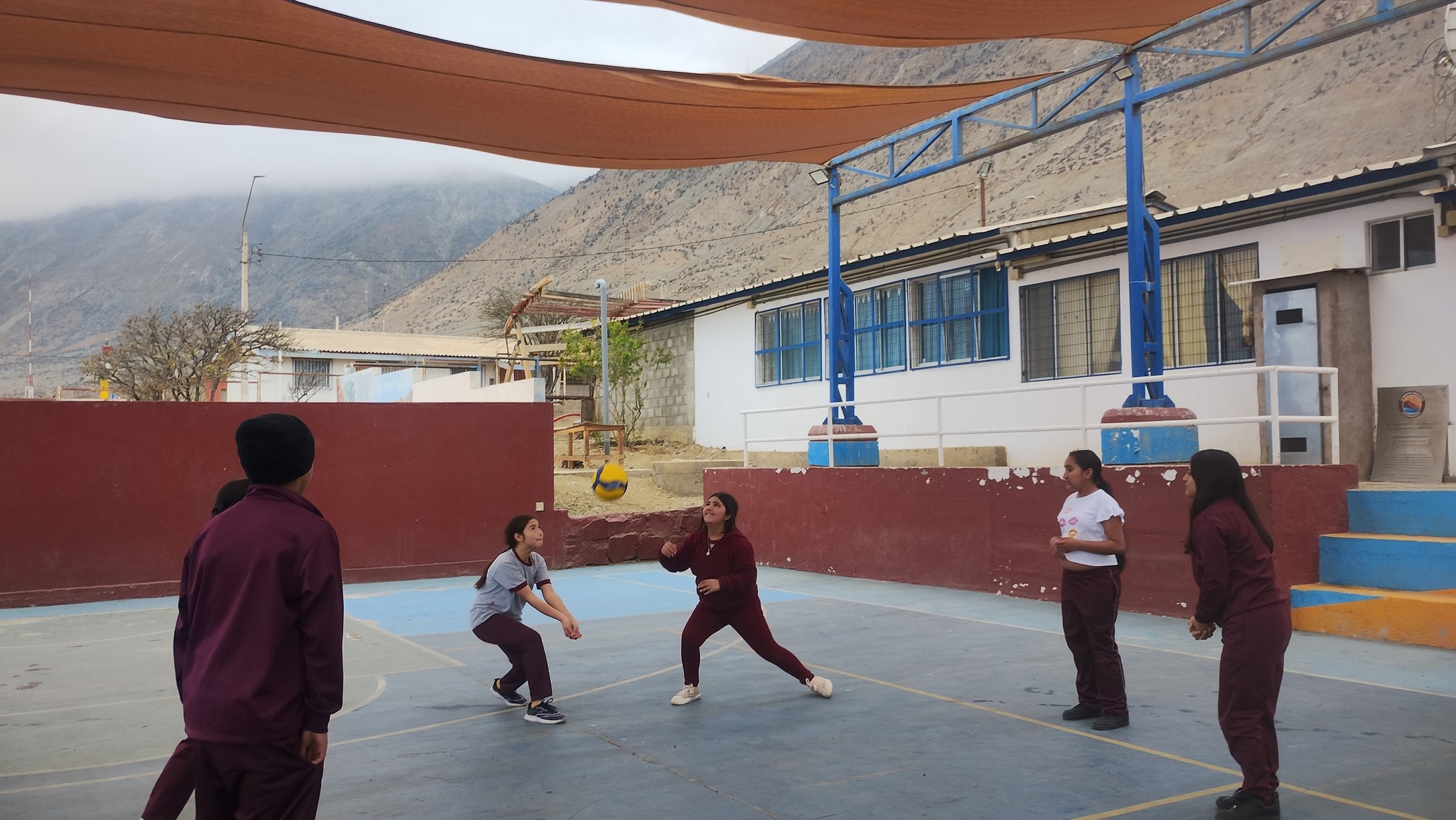 Niñas de la Escuela Paranal de Paposo juegan vóleibol en la cancha techada del establecimiento.