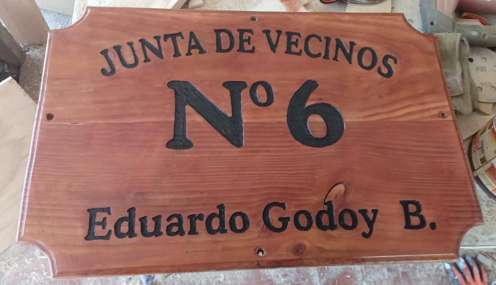 Placa de madera con el nombre de Eduardo Godoy en sede vecinal.
