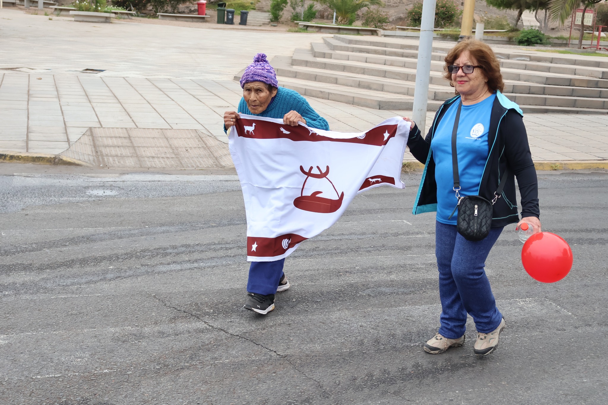 Adultos mayores con bandera changa en mano.