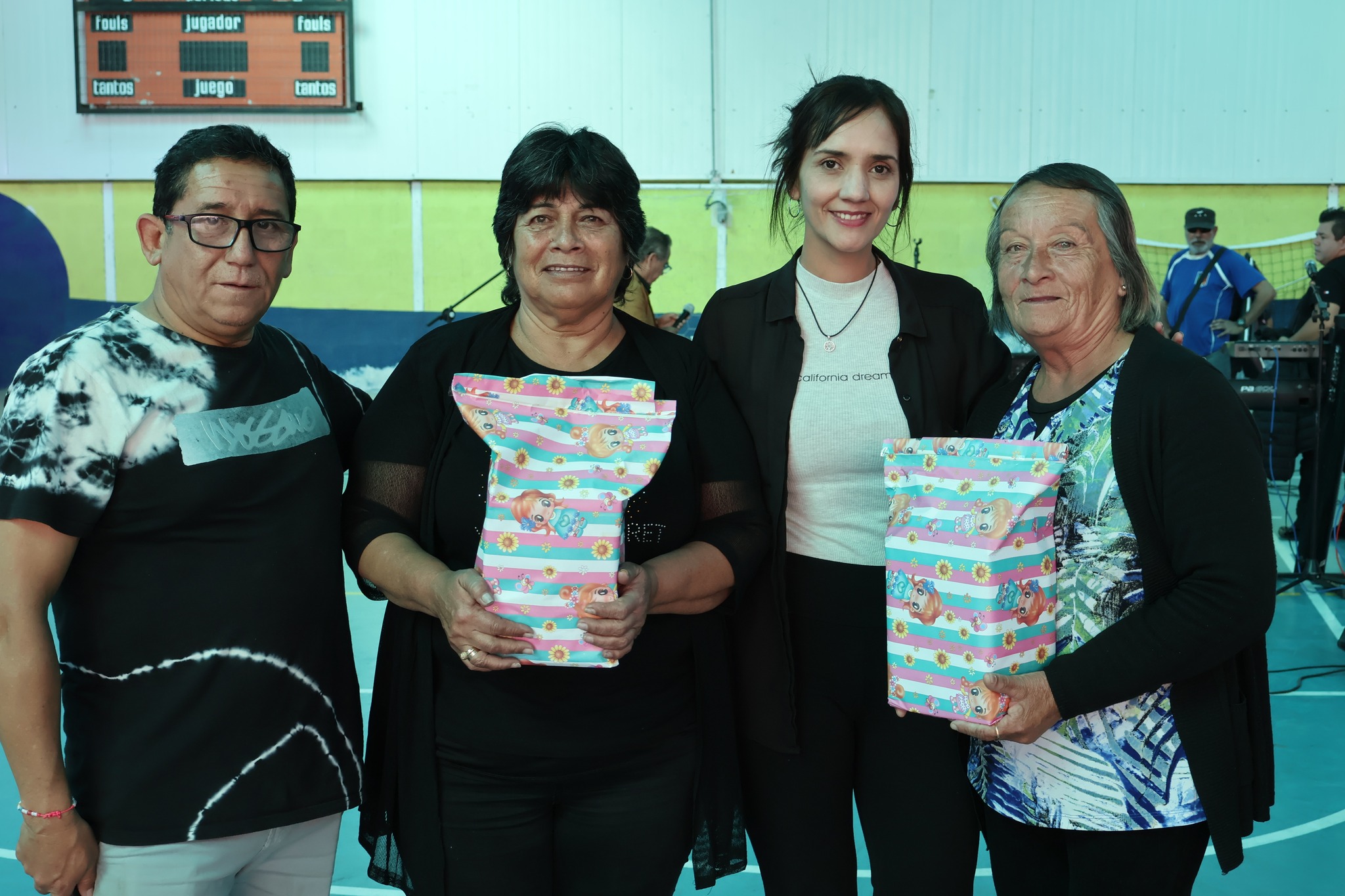 Dos adultas mayores son reconocidas por su participación en la jornada comunal del Mes del Adulto Mayor, junto a autoridades locales.