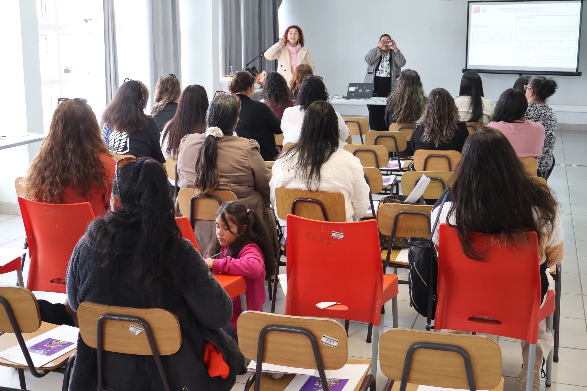 Exposición de administradora municipal frente a asistentes del Programa Mujeres Jefas de Hogar en Taltal.