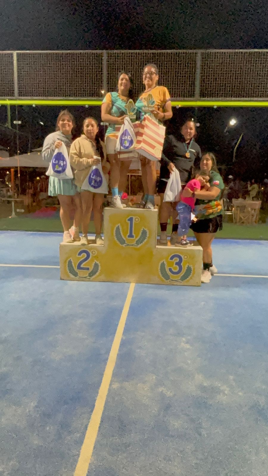 Premiación de la categoría D damas en La Liga Caleta Hueso Pádel 2025, con las jugadoras campeonas posando con trofeos sobre el podio.