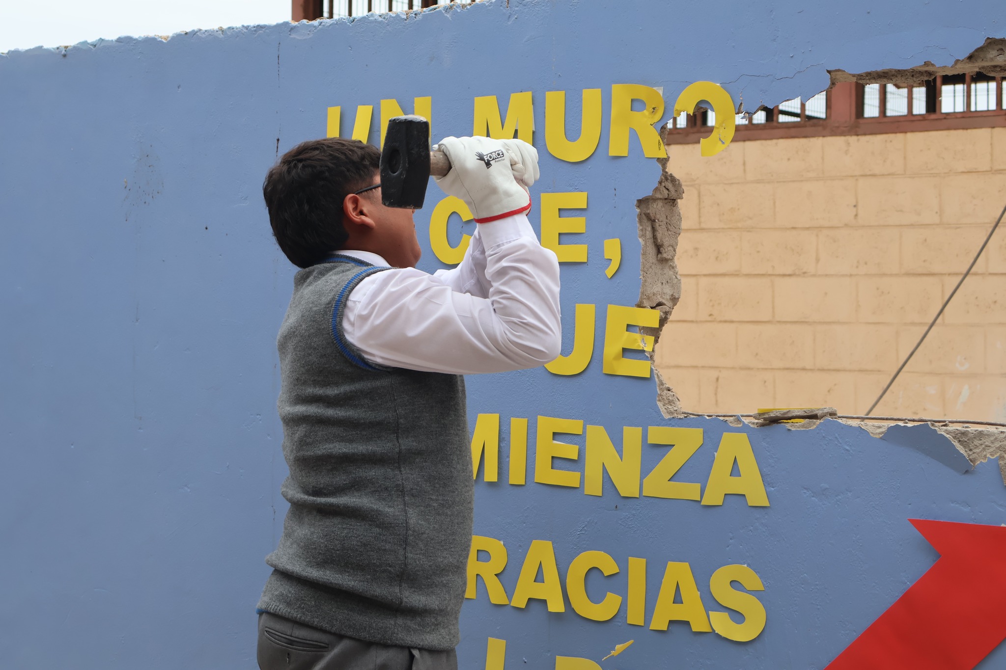 Estudiante del Liceo Politécnico José Miguel Quiroz golpea el muro antiguo durante el acto de cierre.