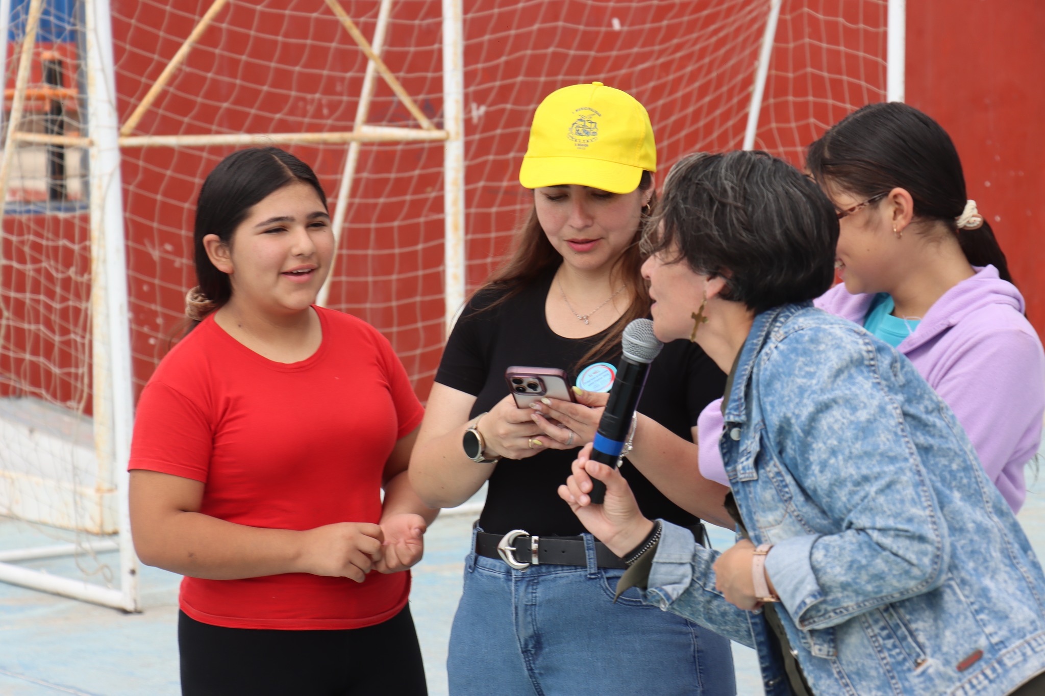 Psicóloga y niñas participando en dinámica de autoestima e interrelaciones durante jornada comunitaria en Paposo.