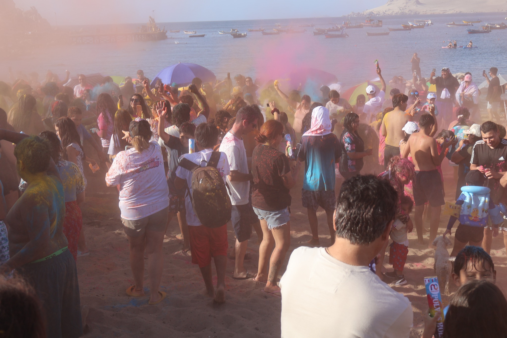 Ambiente festivo durante el sunset con polvos de colores en la caleta de Taltal.