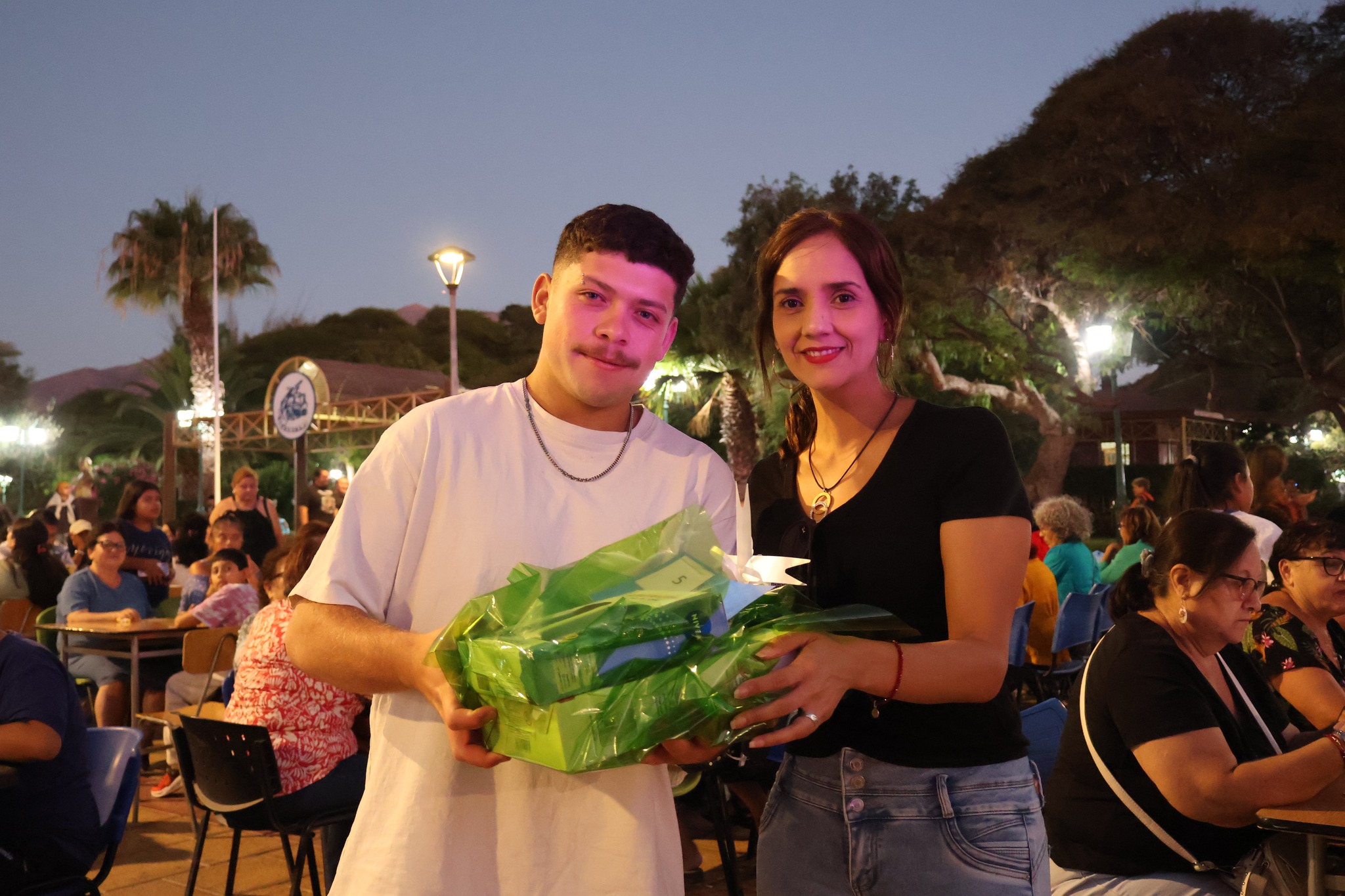 Joven taltalino posando con su premio tras ganar una de las rondas del bingo veraniego.
