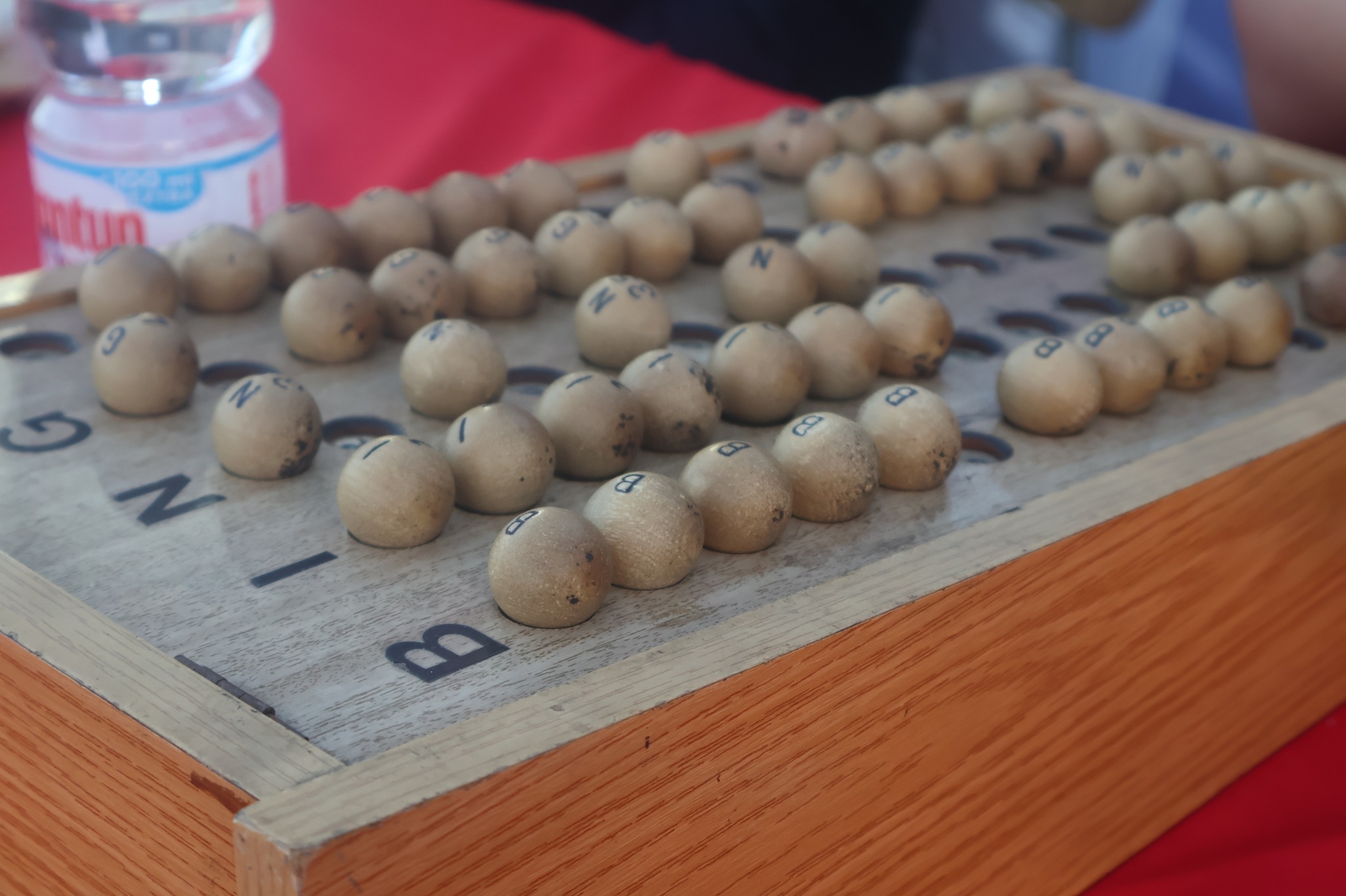 Detalle de tómbola y bolillas del bingo usado en actividad comunitaria del Día de la Mujer en Taltal.