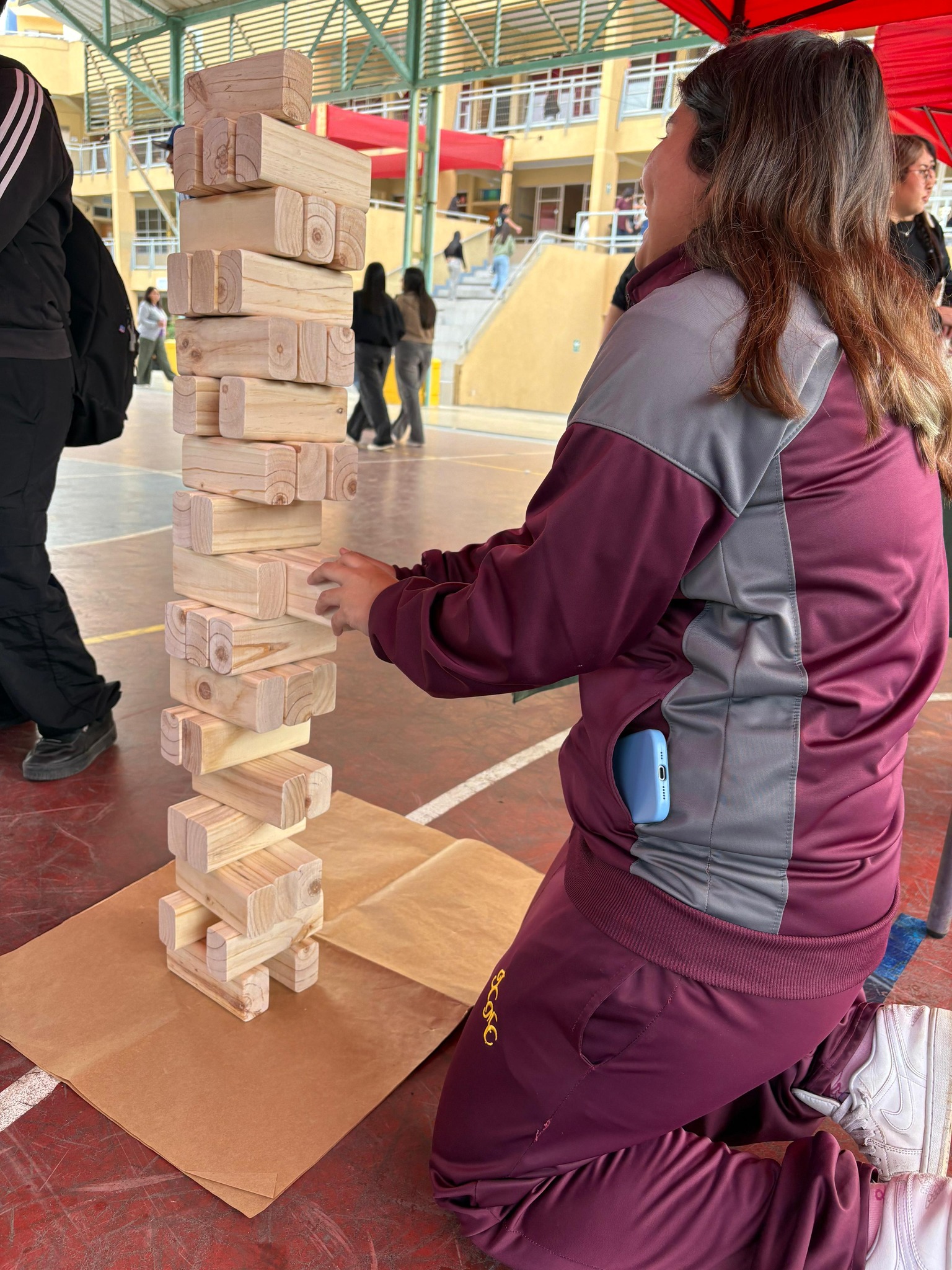 Estudiante participa en juego de jenga preventivo durante actividad de SENDA en Taltal